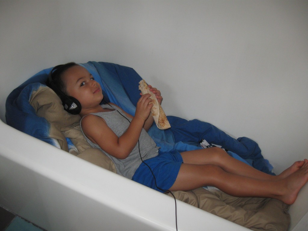 Listening to stories in a bathtub cubby while mom and dad write music